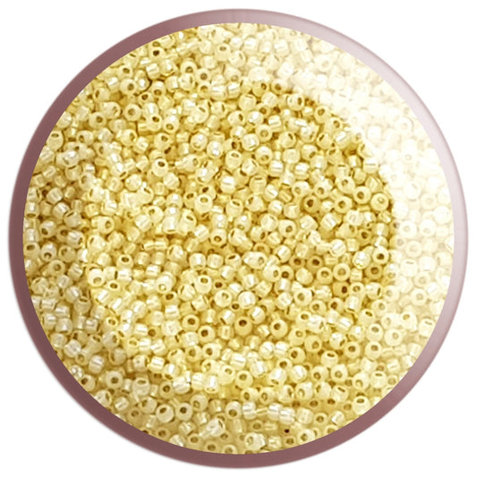 11/0 TR-2125 Milky Jonquil Ceylon Silver Lined Round Toho Seed Beads in a circle white background.