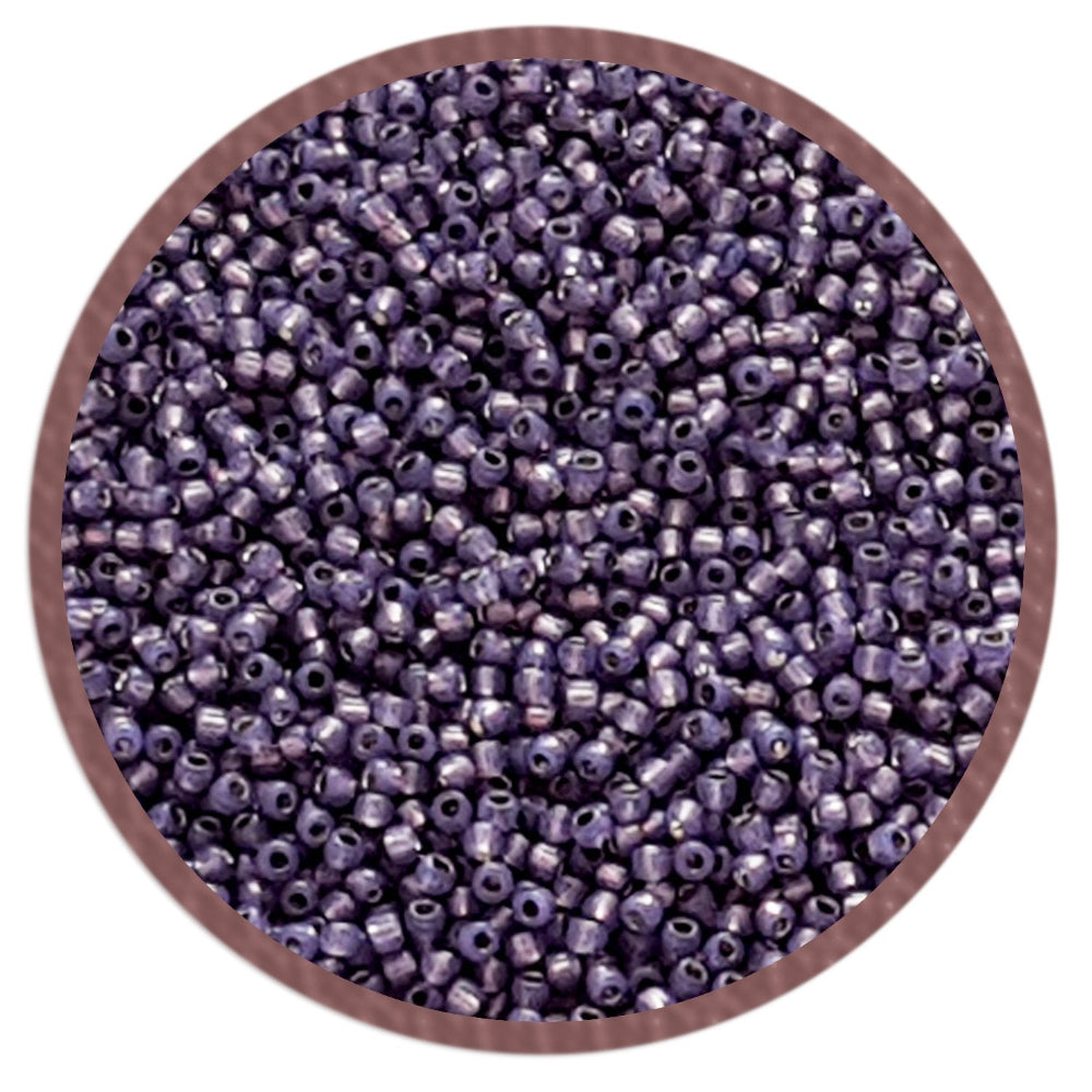 11/0 TR-2124 Milky Lavender Silver Lined Round Toho Seed Beads in a circle white background.