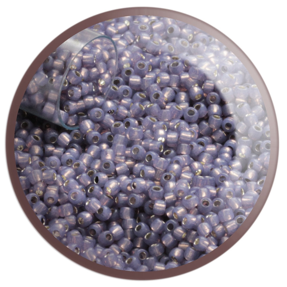 11/0 TR-2124 Milky Lavender Silver Lined Round Toho Seed Beads blurred in a circle white background.