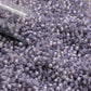 11/0 TR-2124 Milky Lavender Silver Lined Round Toho Seed Beads close up with a tube tip.