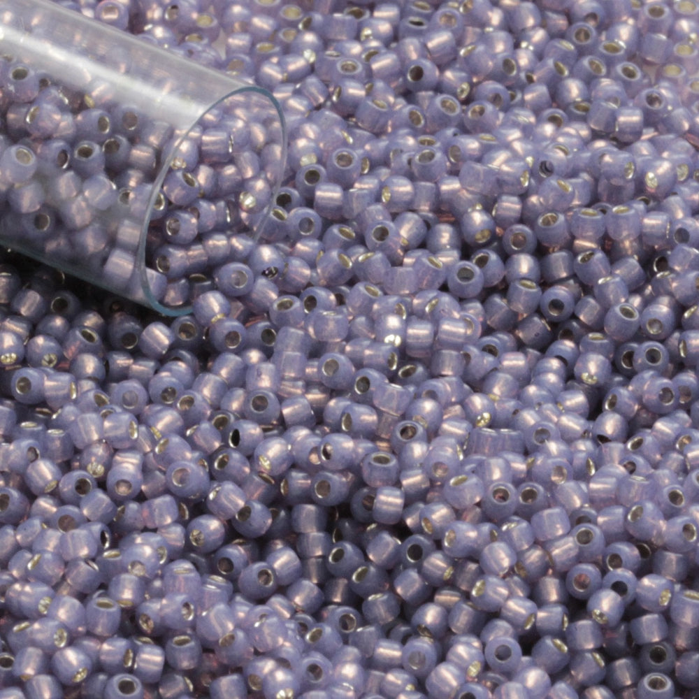 11/0 TR-2124 Milky Lavender Silver Lined Round Toho Seed Beads close up with a tube tip.