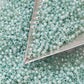11/0 Milky Aqua Toho seed beads with a triangle scoop.