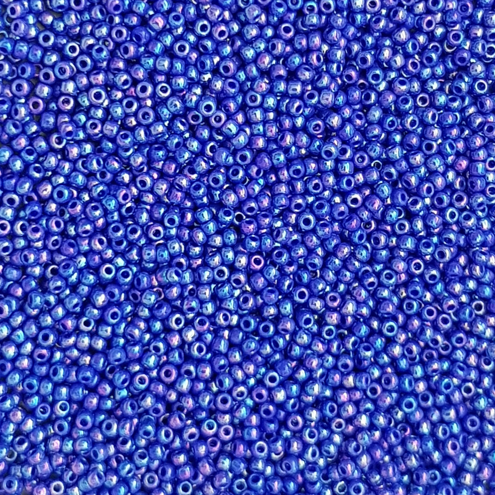 11/0 Toho seed beads in navy blue rainbow opaque close up.