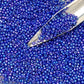 11/0 toho seed  beads in navy rainbow opaque with a beading scoop.