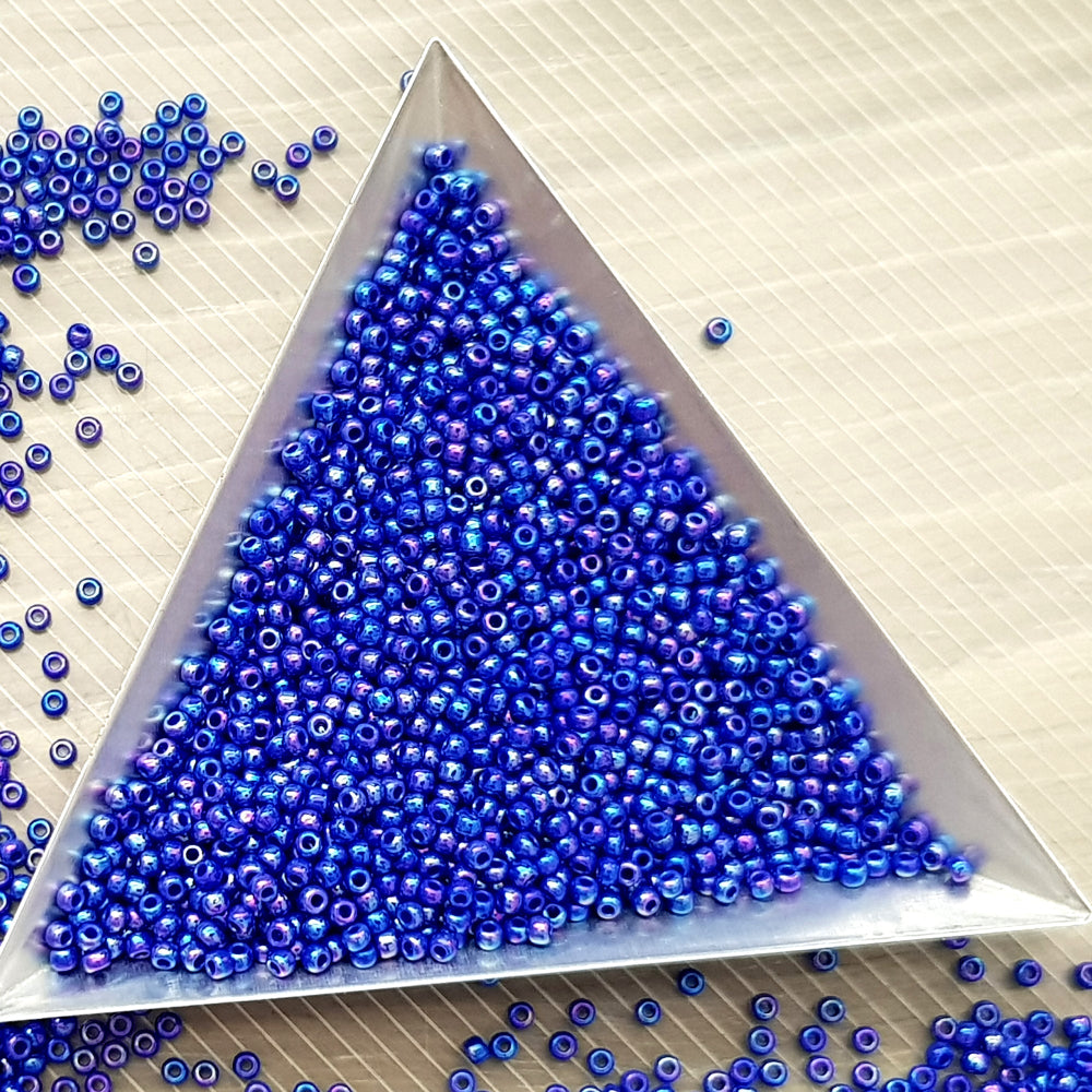 11/0 Toho seed beads in navy blue rainbow opaque with a triangle scoop.