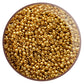 A close-up view of a pack of old gold, round, permanent finish Toho seed beads. 11/0  TR-PF591 in a circle white background.