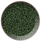 A bowl filled with olivine frosted transparent round Toho seed beads. 11/0 TR-940F