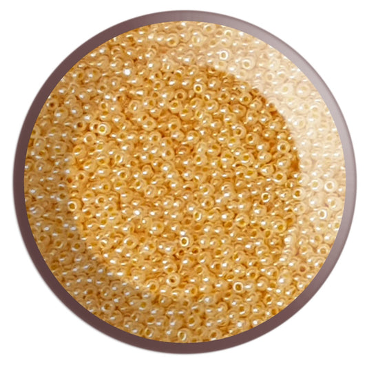11/0 TR-148 Peach Cobbler Ceylon Round Toho Seed Beads in a circle white background.