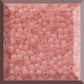 A close-up view of pink frosted round Toho seed beads.11/0 square window.