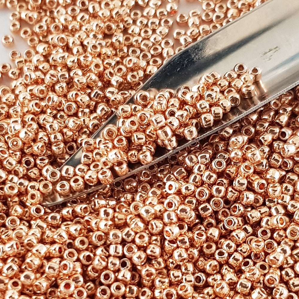 11/0 Toho Seed Beads in Rose Gold Galvanized Permanent Finish TR-PF551 with a beading scoop.