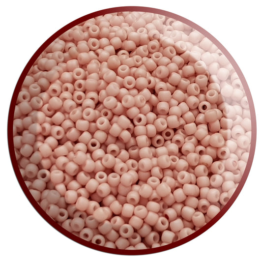 A close-up of round, shrimp frosted opaque pastel color Toho seed beads in a circle white background.
