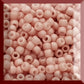 Close shrimp Frosted Opaque Pastel 11/0  Toho beads in a square window.
