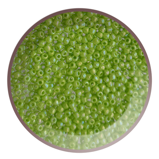 11/0 Toho seed beads in sour apple rainbow opaque TR-404 in a circle white background.