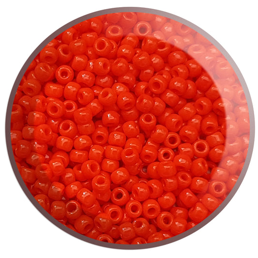 close up orange beads in a round container