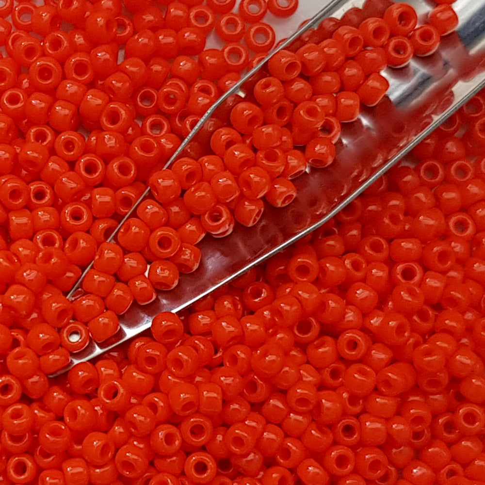 close up orange beads with a thin scoop