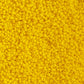 11/0 Toho seed beads in sunshine yellow opaque frosted close up.