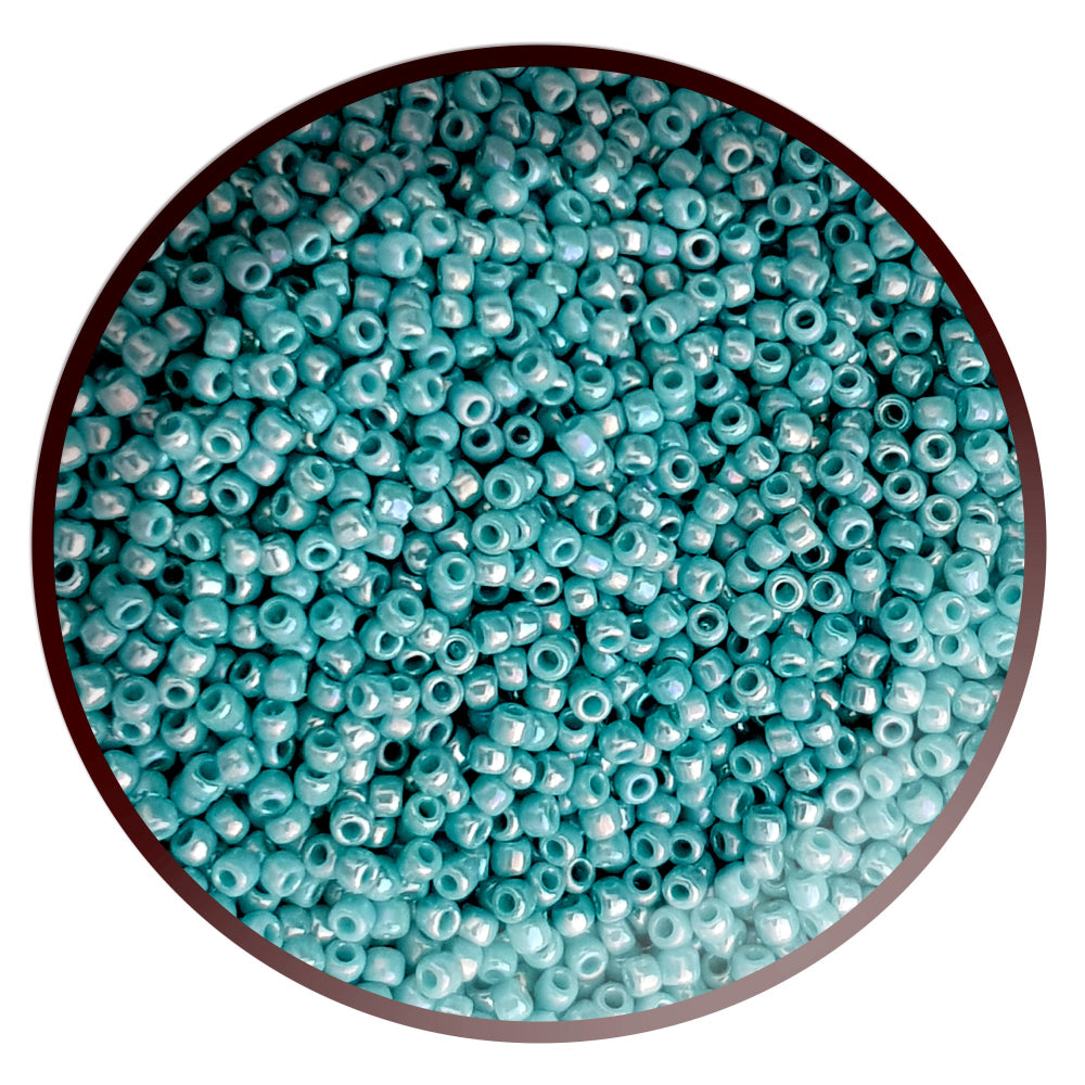 11/0 Toho seed beads in turquoise opaque rainbow in a circle white background.