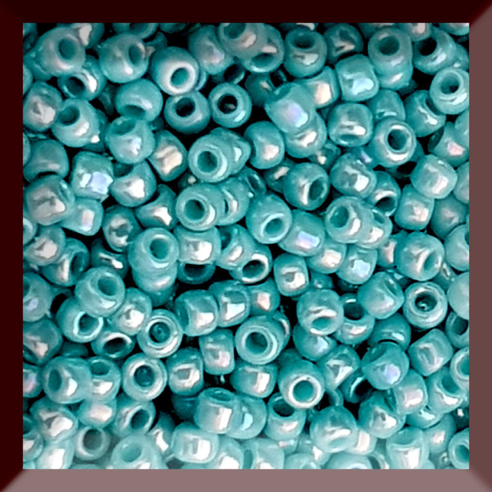 11/0 Toho seed beads in turquoise opaque rainbow in a square window.