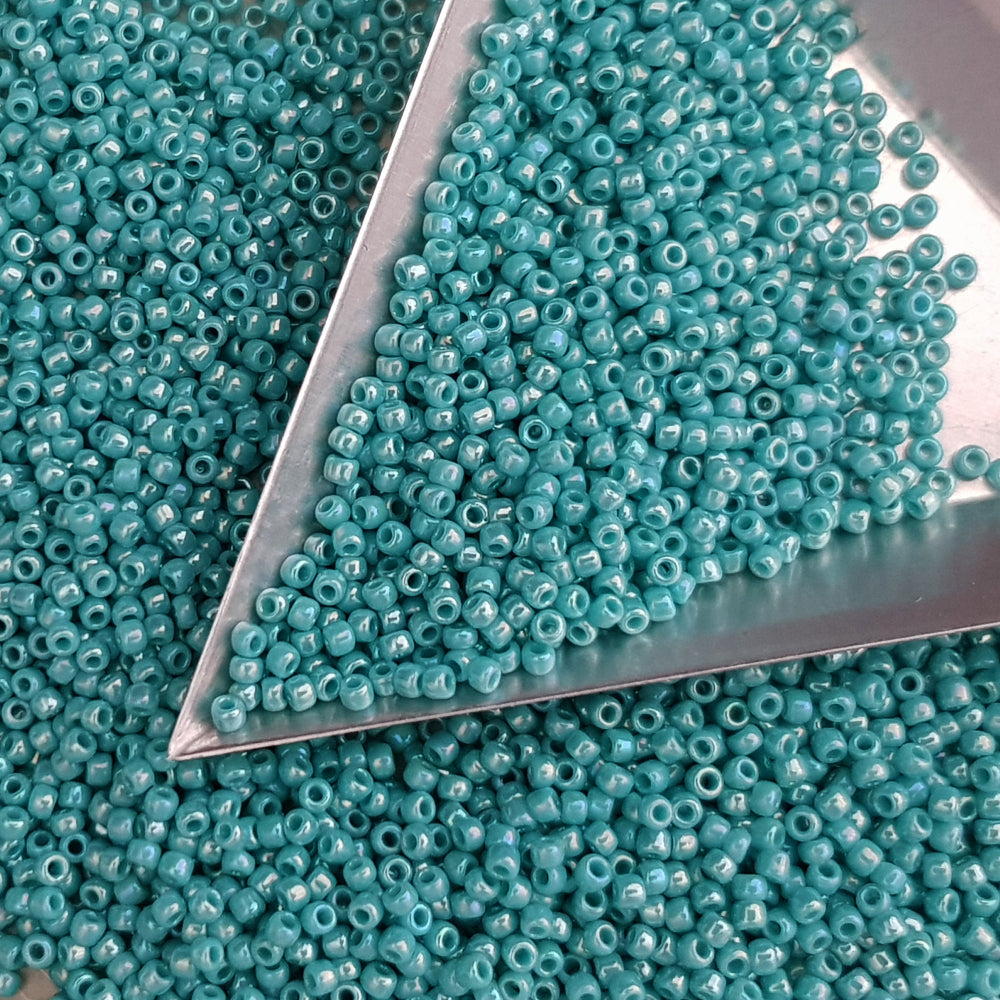 11/0 Toho seed beads in turquoise opaque rainbow with a triangle scoop.