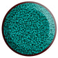 11/0 Toho seed beads in turquoise opaque in a circle white background.