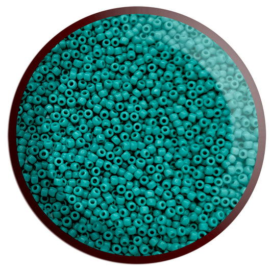 11/0 Toho seed beads in turquoise opaque in a circle white background.