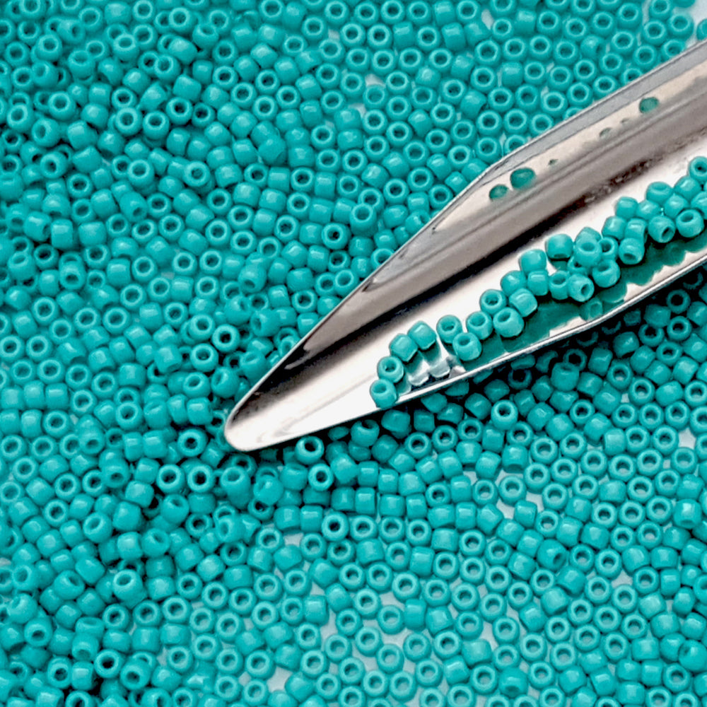 11/0 Toho seed beads in turquoise opaque TR-55 with a beading scoop.