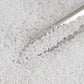 Toho 11/0 White Opaque TR-41 in a close up with beading scoop.