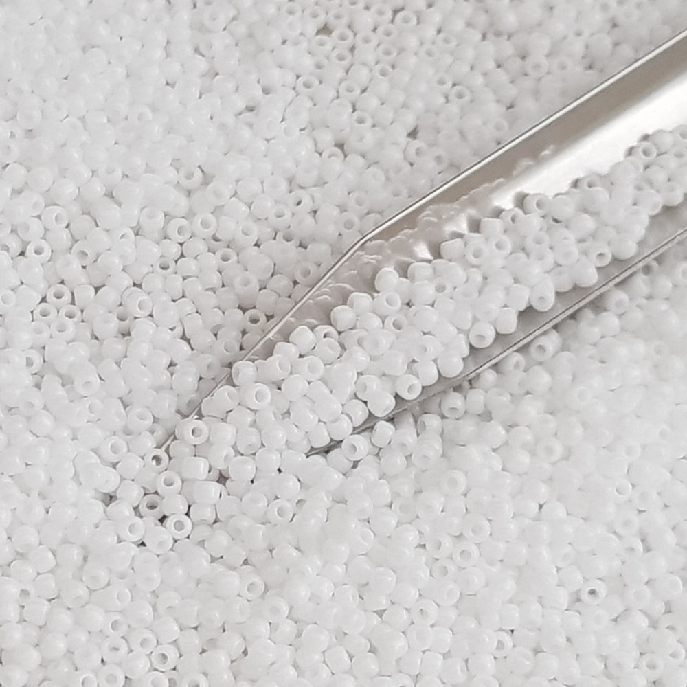 Toho 11/0 White Opaque TR-41 in a close up with beading scoop.