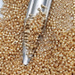 11/0 Toho Seed Beads in Starlight Gold Galvanize Permanent Finish TR-PF557 with a beading scoop.