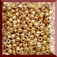 11/0 Toho seed beads in starlight gold galvanized permanent finish TR-PF557 in a square window.