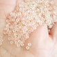 15/0 Toho Seed Beads in Rosaline Pink Frosted Transparent TR-11f on a hand.