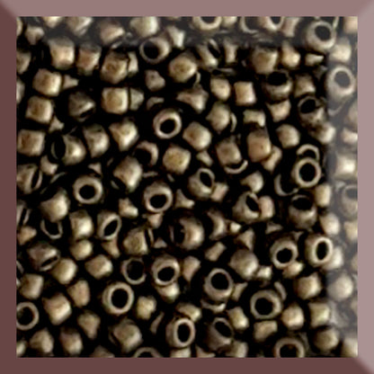 A close-up image of gold metallic round Toho seed beads with a suede hybrid finish.
