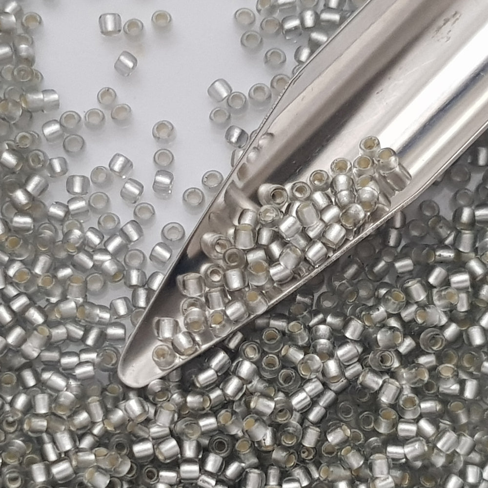 8/0 Toho seed Beads in Black Diamond Silver-Lined Matte TR-29AF with a beading scoop.