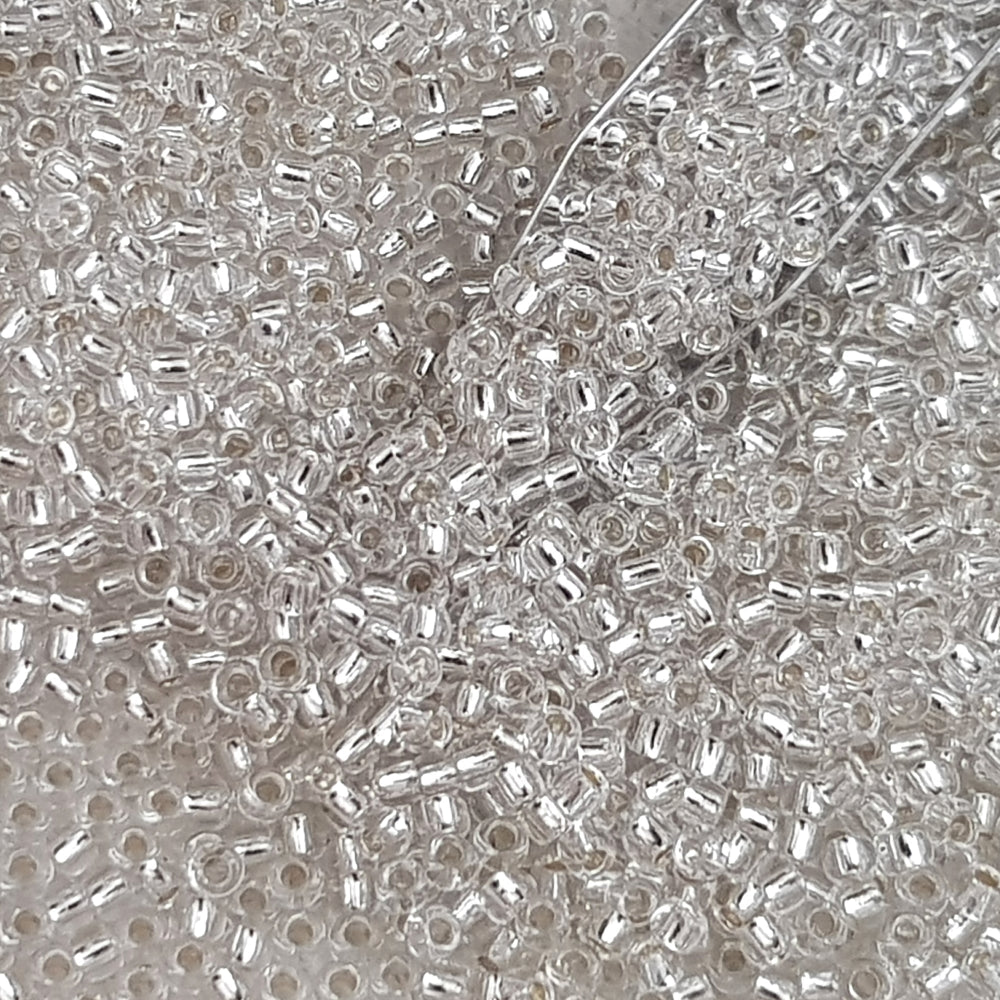8/0 Toho Seed Beads in a crystal silver-lined TR-21 with a beading scoop.