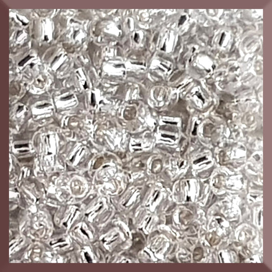 8/0 Toho Seed Beads in Crystal Silver-Lined TR-21 square window.