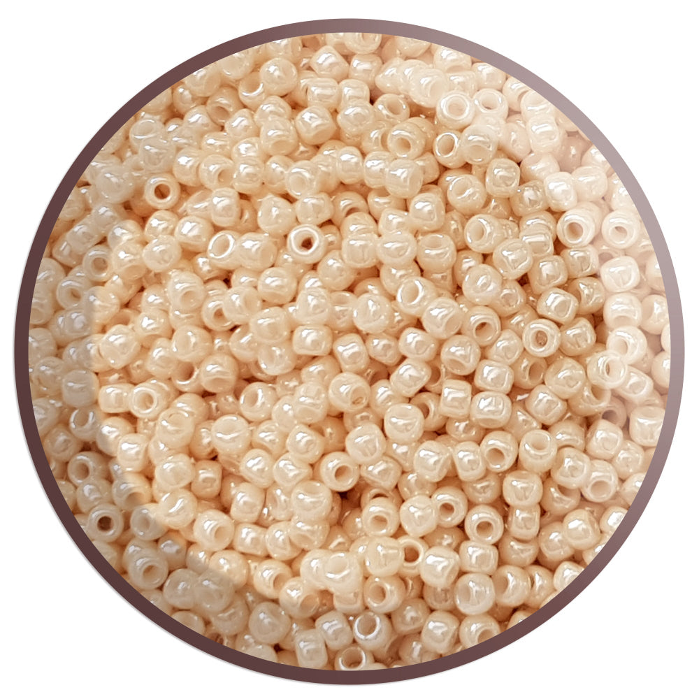 8/0 toho seed beads in lt beige luster opaque TR-123 in a circle white background.