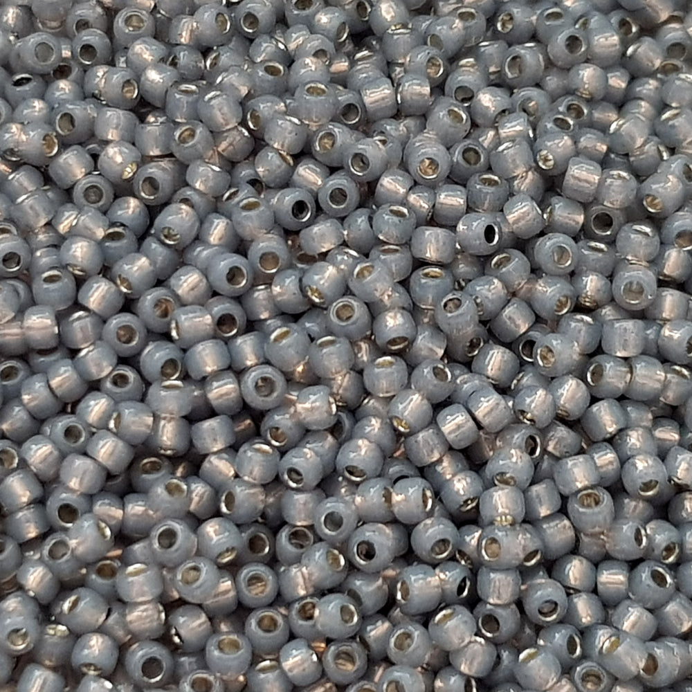 8/0 Toho Seed Beads in Milky Grey Silver-Lined TR-2115 close up.