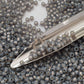 8/0 Toho Seed Beads in Milky Grey Silver-Lined TR-2115 with a beading scoop.