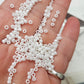 8/0 Toho Seed beads in white luster opaque TR-121 close up on a hand.