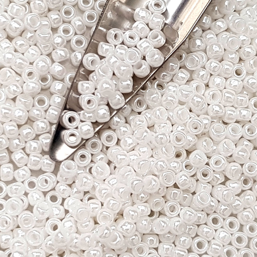8/0 Toho Seed beads in white luster opaque with a beading scoop.