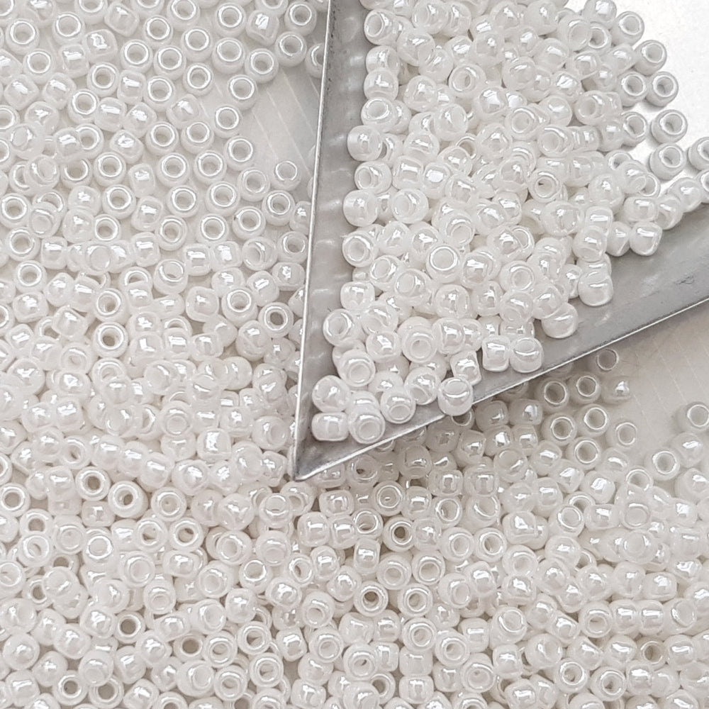 8/0 Toho seed beads in white luster opaque TR-121 with triangle scoop.