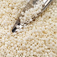 8/0 Toho seed beads in white Navajo luster opaque TR-122 with a beading scoop.