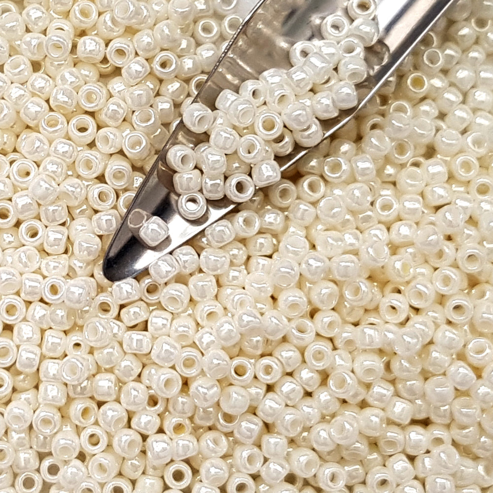 8/0 Toho seed beads in white Navajo luster opaque TR-122 with a beading scoop.