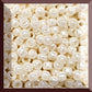 A close-up image of white opaque round Toho seed beads. 8/0 TR-122 square window.