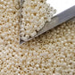 8/0 Toho Seed beads in white Navajo luster opaque TR-122 with a triangle scoop