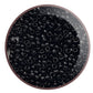 Toho seed beads 15/0 jet black opaque TR-49 in a circle white background.