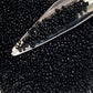 Toho seed beads 15/0 jet black opaque TR-49 with a beading scoop