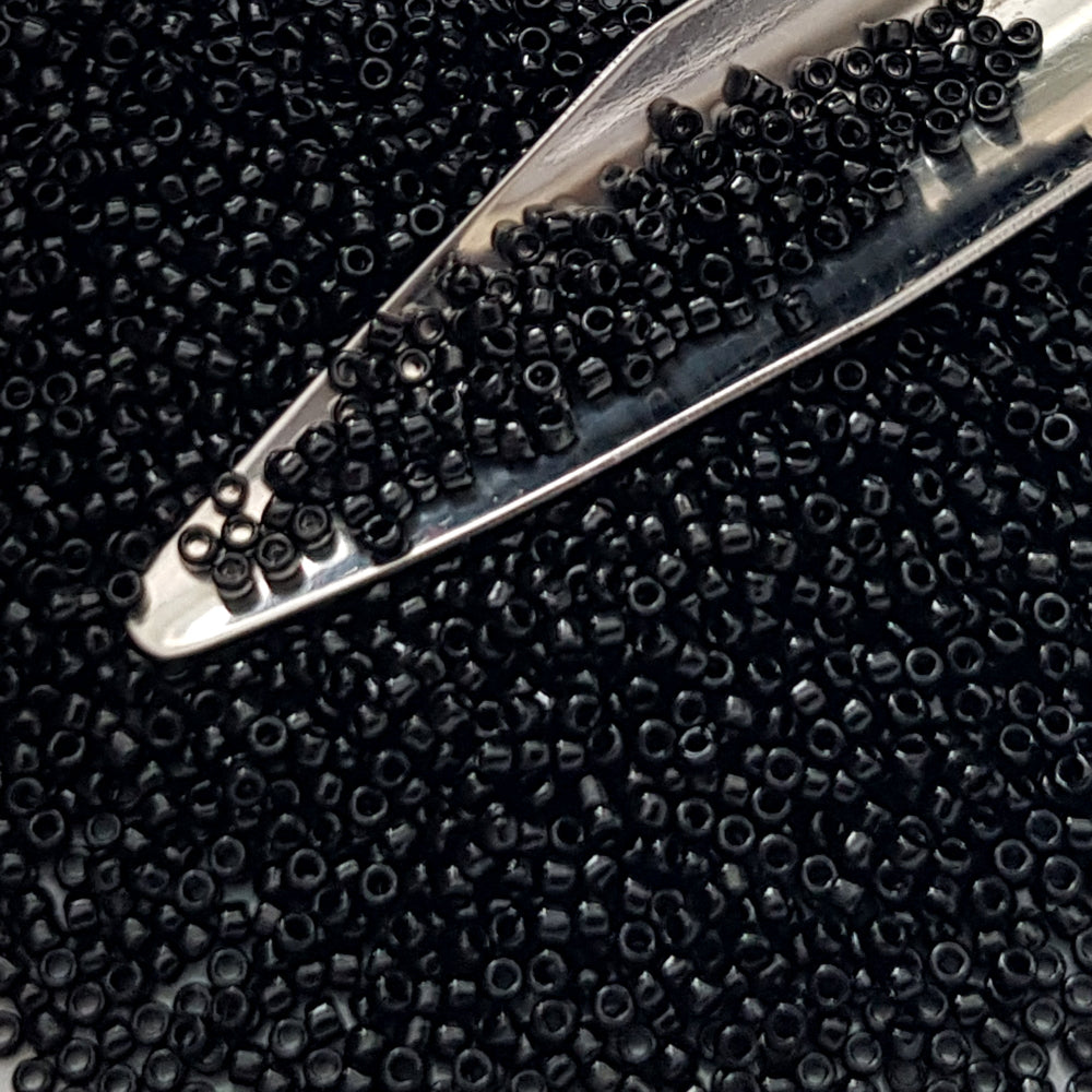 Toho seed beads 15/0 jet black opaque TR-49 with a beading scoop