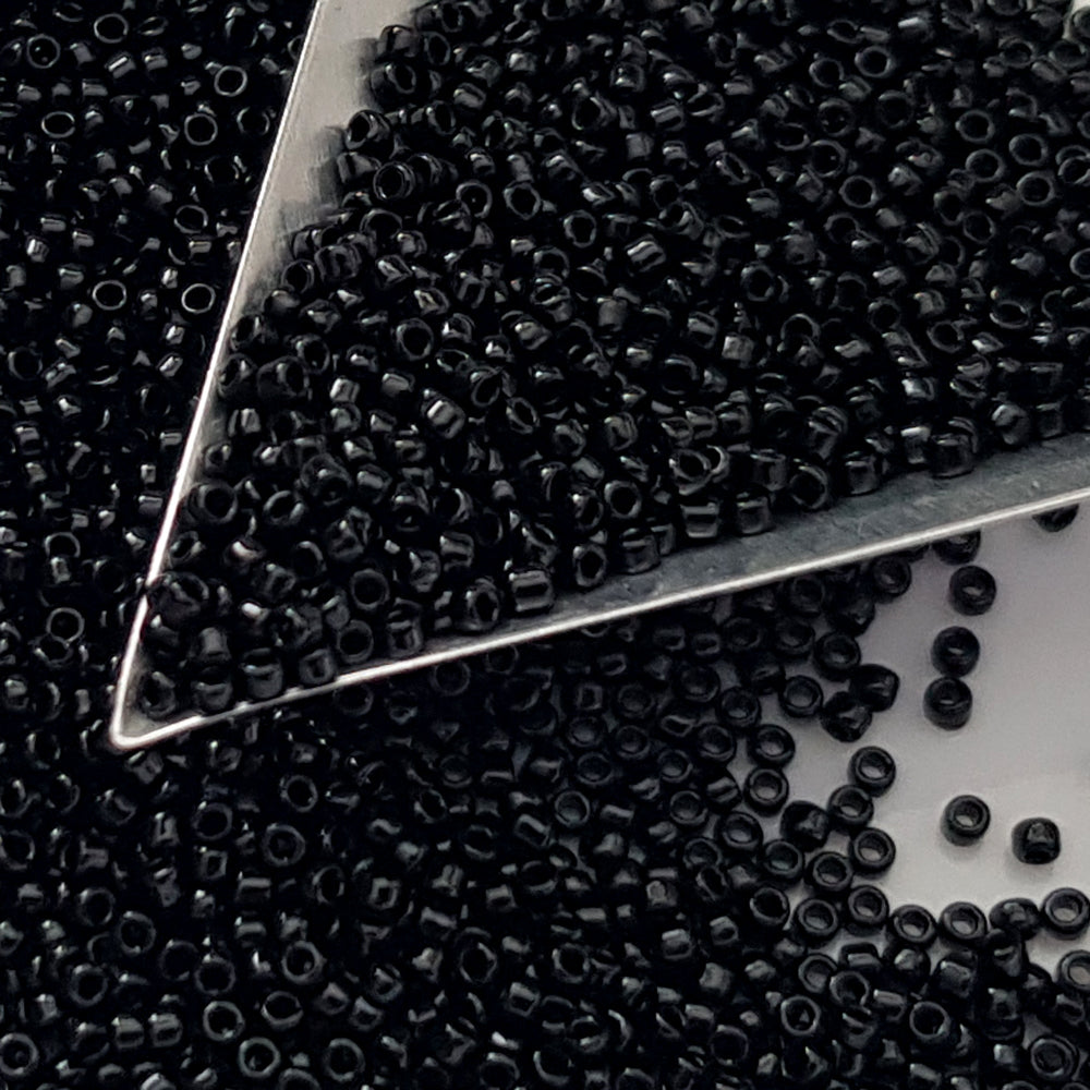 Toho seed beads 15/0 jet black opaque TR-49 with a triangle scoop.